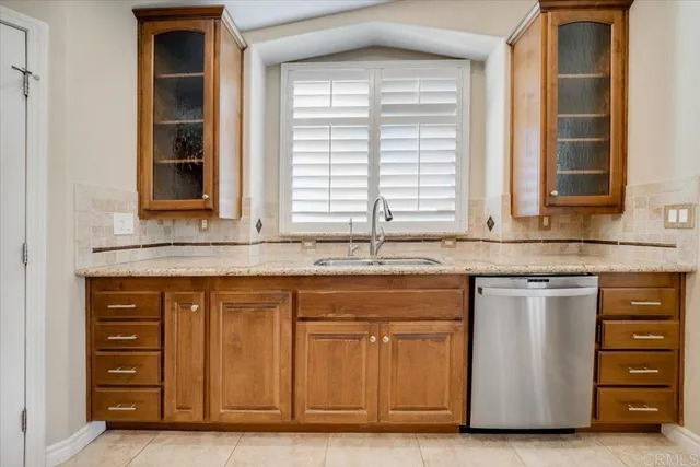 a kitchen with stainless steel appliances granite countertop a sink and a stove