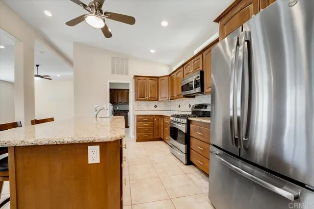 a kitchen with stainless steel appliances granite countertop a refrigerator a oven a sink and dishwasher