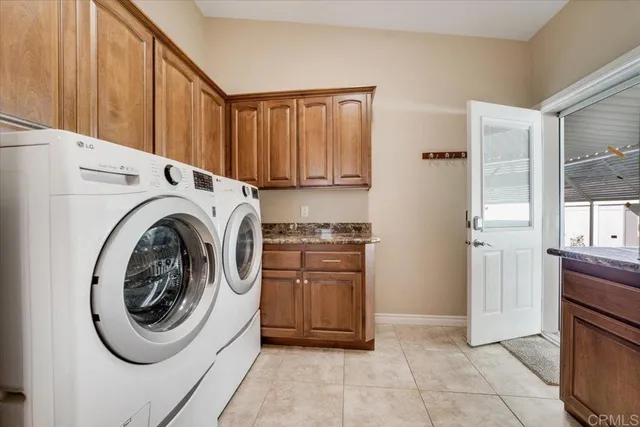 a utility room with sink dryer and washer