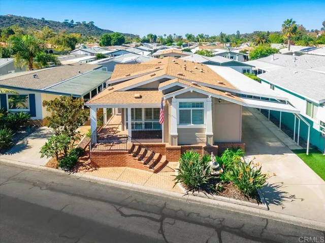 an aerial view of a house with a swimming pool yard and mountain view in back
