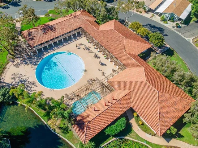 a view of a swimming pool with a garden and plants