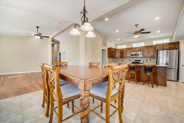 a view of a dining room with furniture and a chandelier
