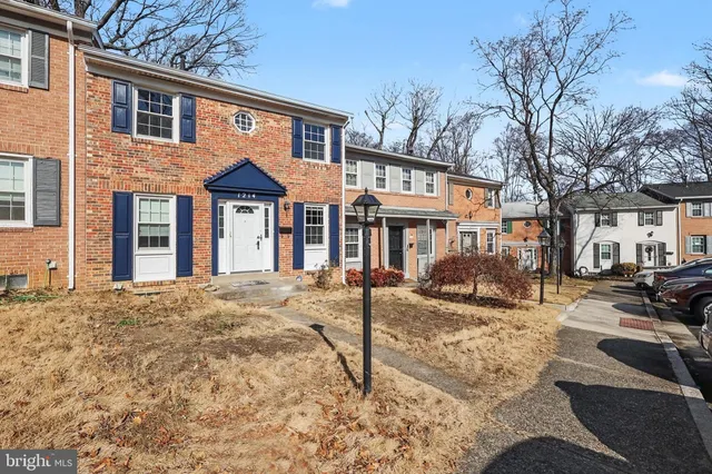 a front view of a residential apartment building with a yard
