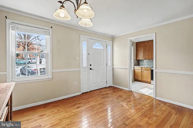 a view of a big room with wooden floor and windows