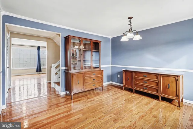 a living room with furniture and wooden floors