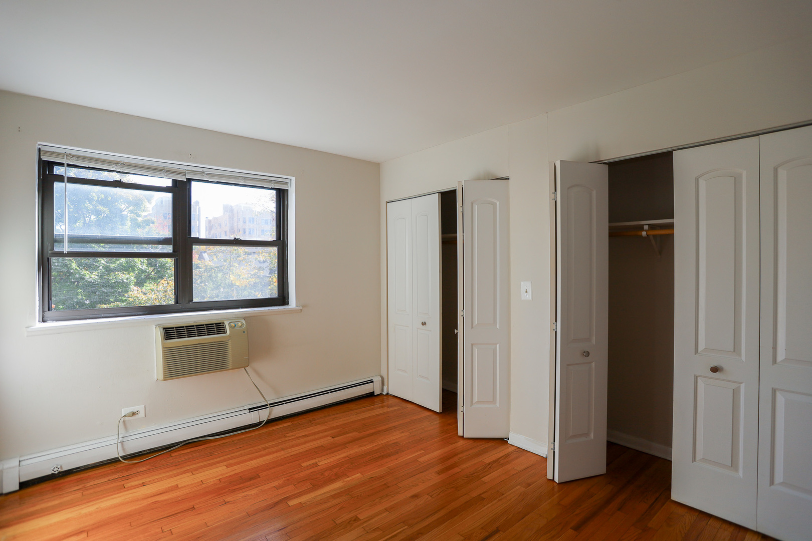 606 West Cornelia Avenue, Unit 482 Chicago, IL 60657 - Photo 5 of 13 an empty room with wooden floor closet and windows