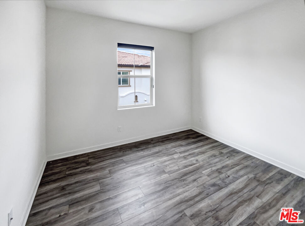 402 Echo Blue Lake Forest, CA 92610 - Photo 12 of 18 an empty room with wooden floor and windows