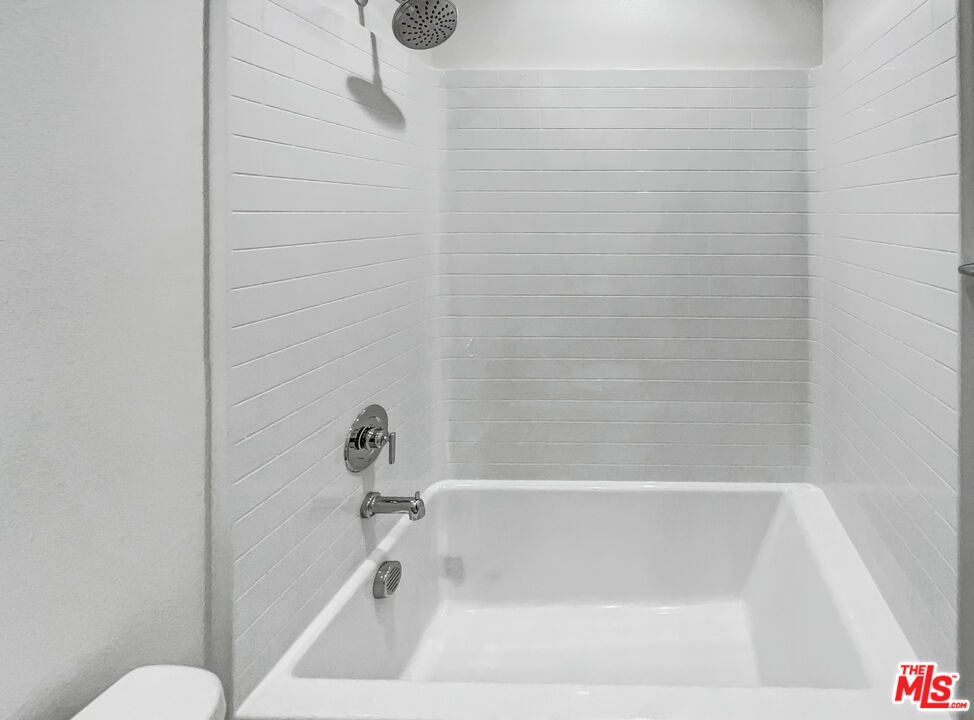 402 Echo Blue Lake Forest, CA 92610 - Photo 14 of 18 a bathroom with a bathtub