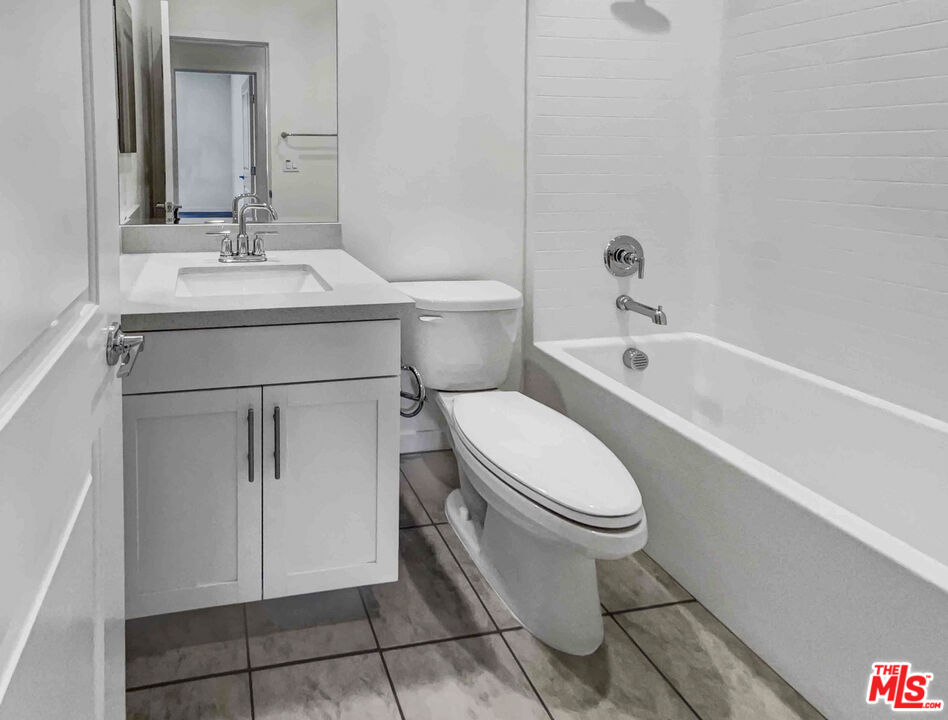 402 Echo Blue Lake Forest, CA 92610 - Photo 15 of 18 a bathroom with a sink a toilet and shower