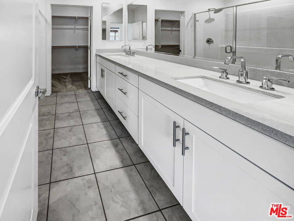 402 Echo Blue Lake Forest, CA 92610 - Photo 16 of 18 a spacious bathroom with a double vanity sink a vanity and a mirror