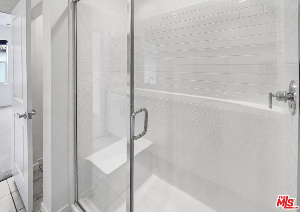 402 Echo Blue Lake Forest, CA 92610 - Photo 17 of 18 a bathroom with a glass shower door