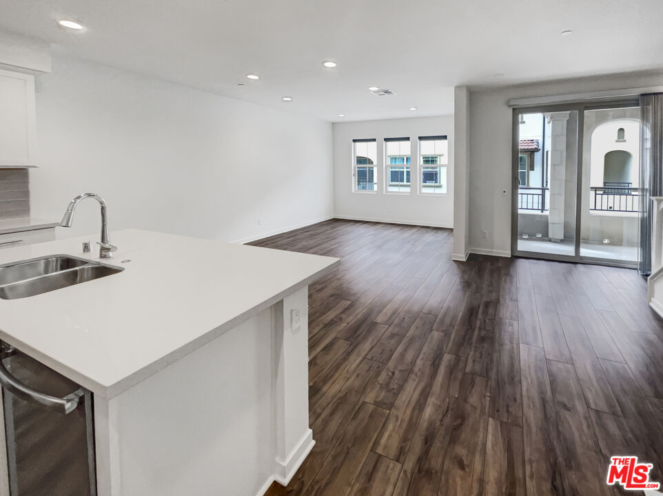 402 Echo Blue Lake Forest, CA 92610 - Photo 3 of 18 a kitchen with a wooden floor and window