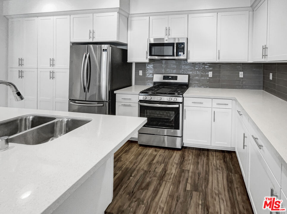 402 Echo Blue Lake Forest, CA 92610 - Photo 10 of 18 a kitchen with stainless steel appliances a refrigerator sink and microwave