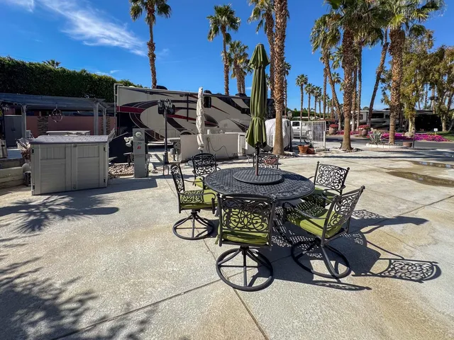 a view of a backyard with sitting area