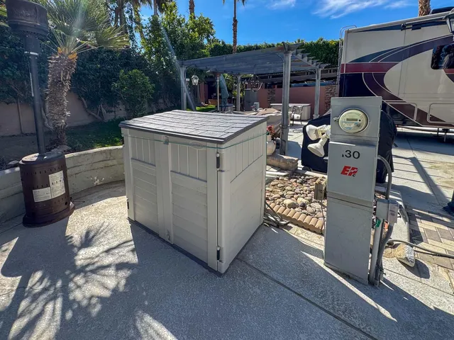 a view of a patio with table and chairs potted plants