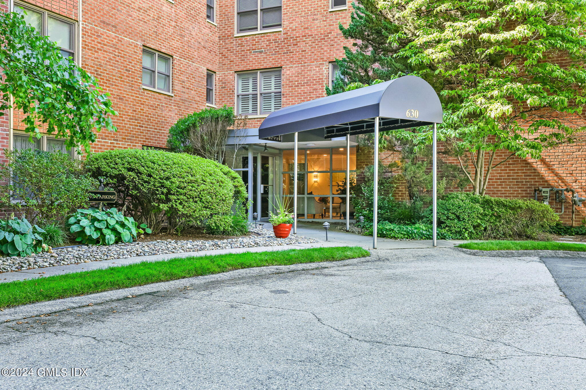 630 Steamboat Road, Unit 3CN Greenwich, CT 06830 - Photo 1 of 19 a view of a patio with table and chairs under an umbrella