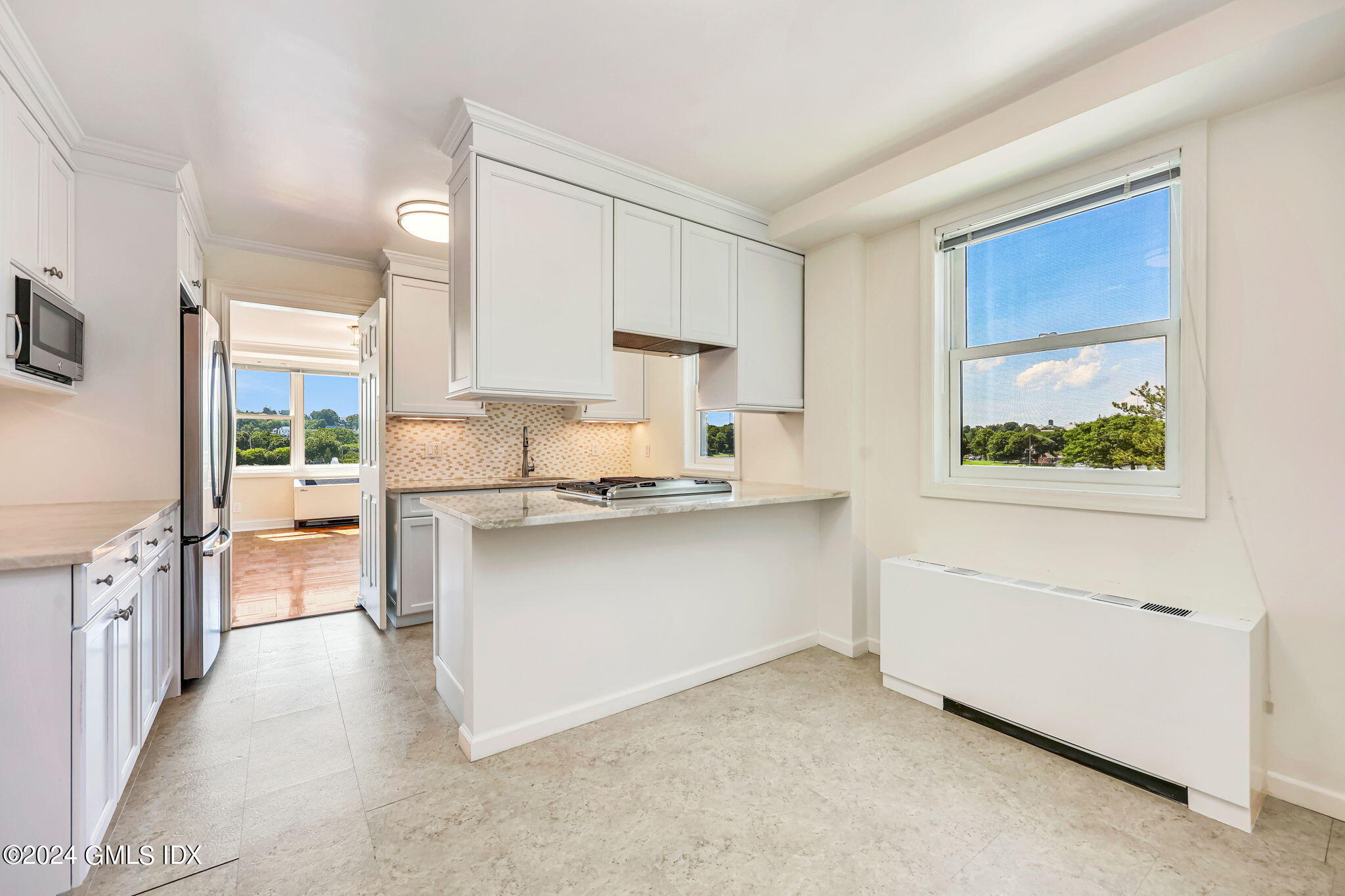 630 Steamboat Road, Unit 3CN Greenwich, CT 06830 - Photo 11 of 19 a kitchen with stainless steel appliances white cabinets and a window
