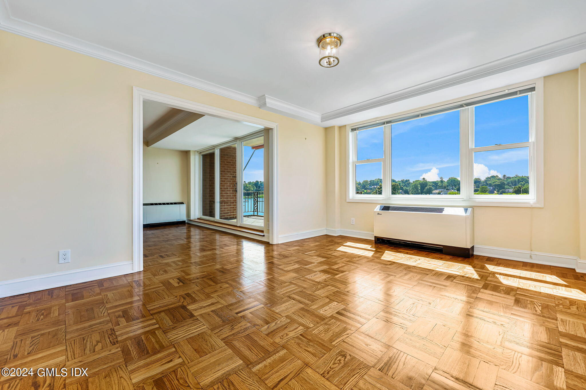 630 Steamboat Road, Unit 3CN Greenwich, CT 06830 - Photo 9 of 19 a view of an empty room with a window and wooden floor