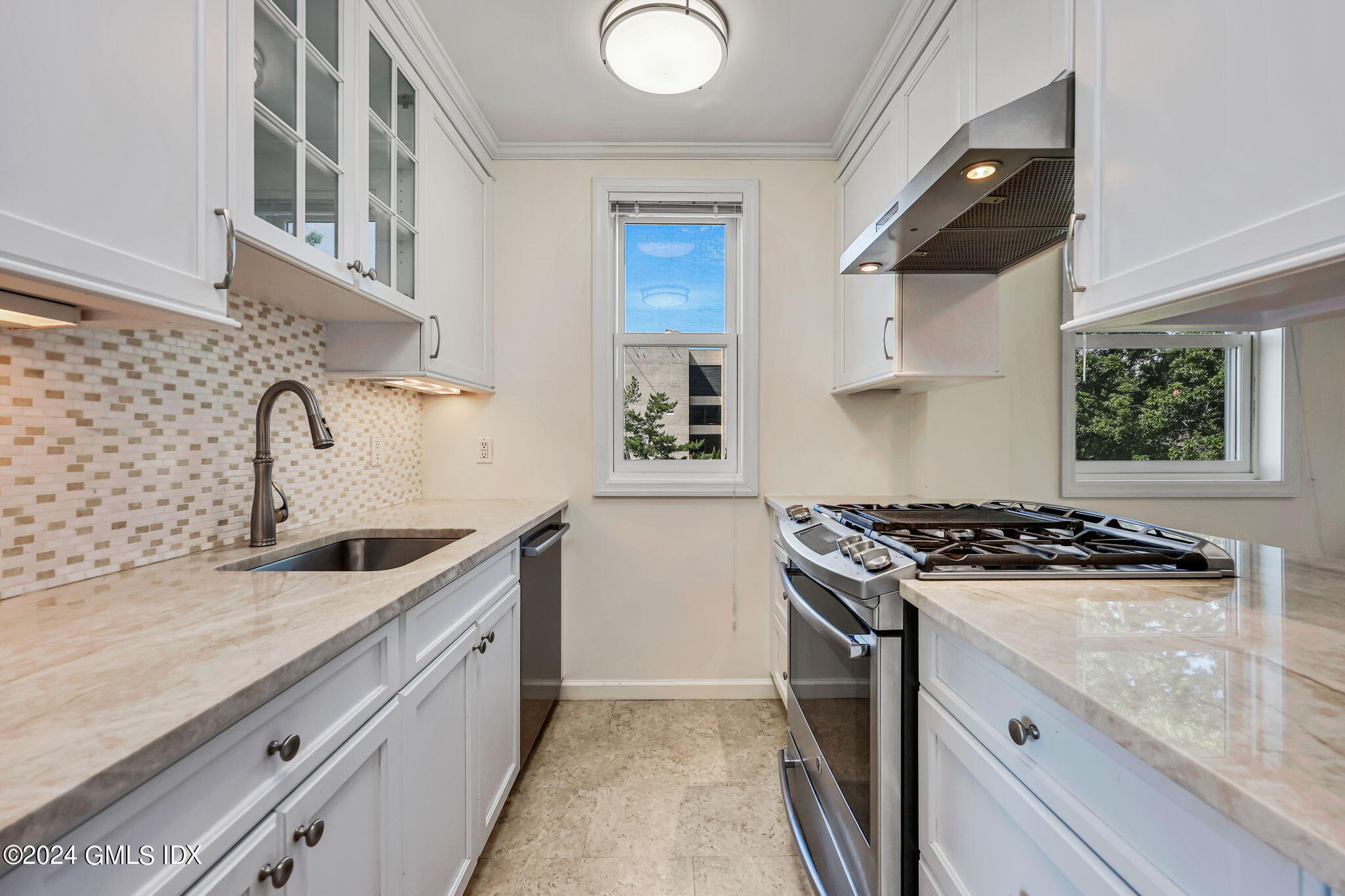 630 Steamboat Road, Unit 3CN Greenwich, CT 06830 - Photo 10 of 19 a kitchen with granite countertop a sink stove and refrigerator