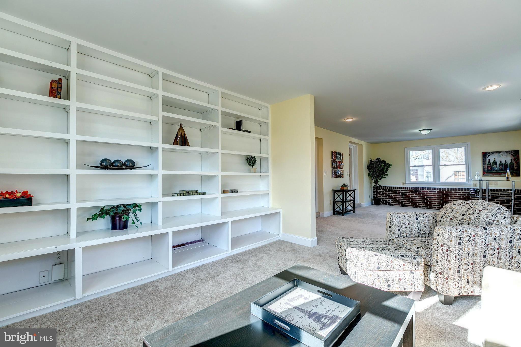 1308 Ramblewood Road Baltimore, MD 21239 - Photo 14 of 30 a living room with furniture and a book shelf