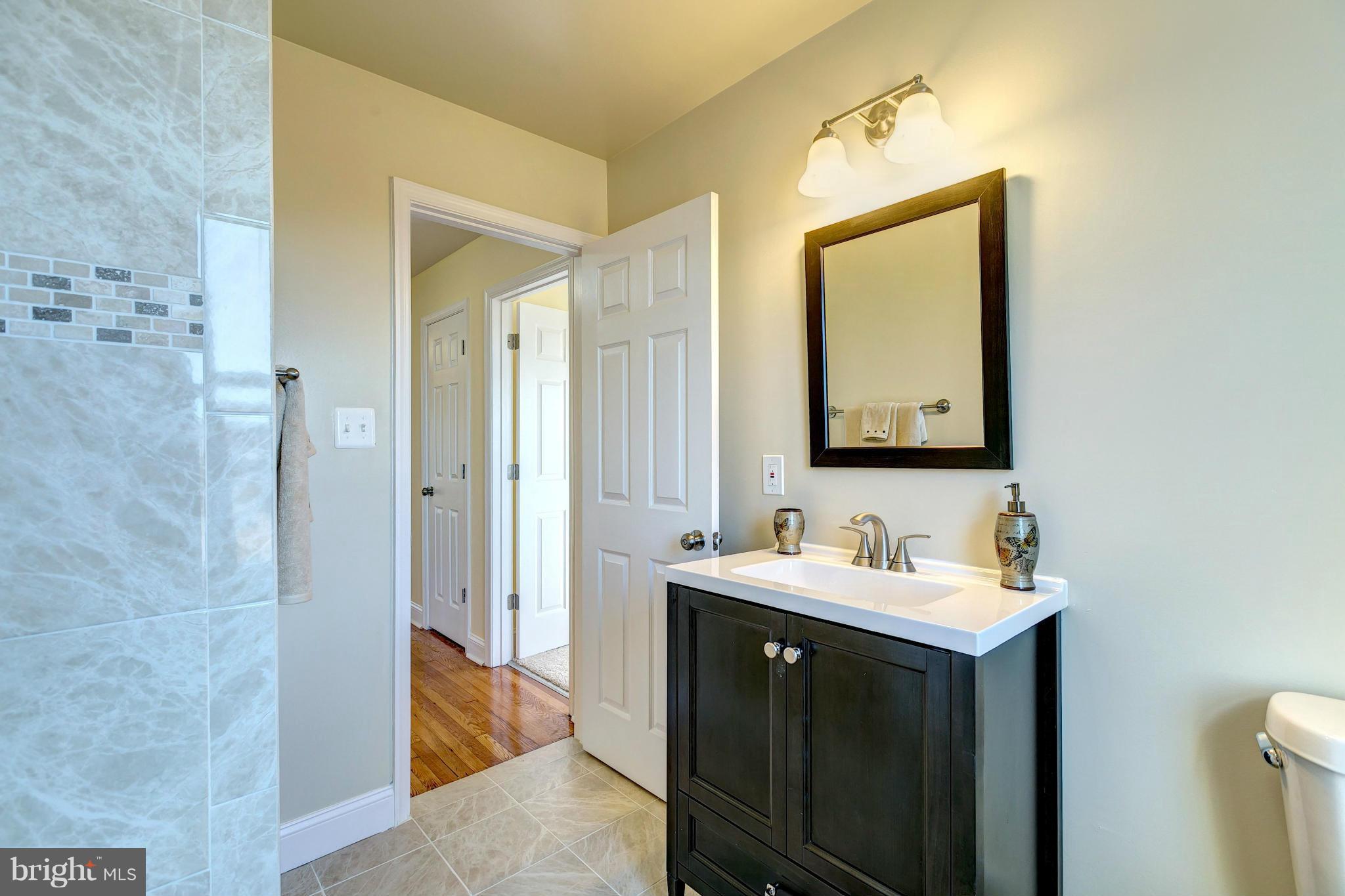 1308 Ramblewood Road Baltimore, MD 21239 - Photo 22 of 30 a bathroom with a sink and a mirror