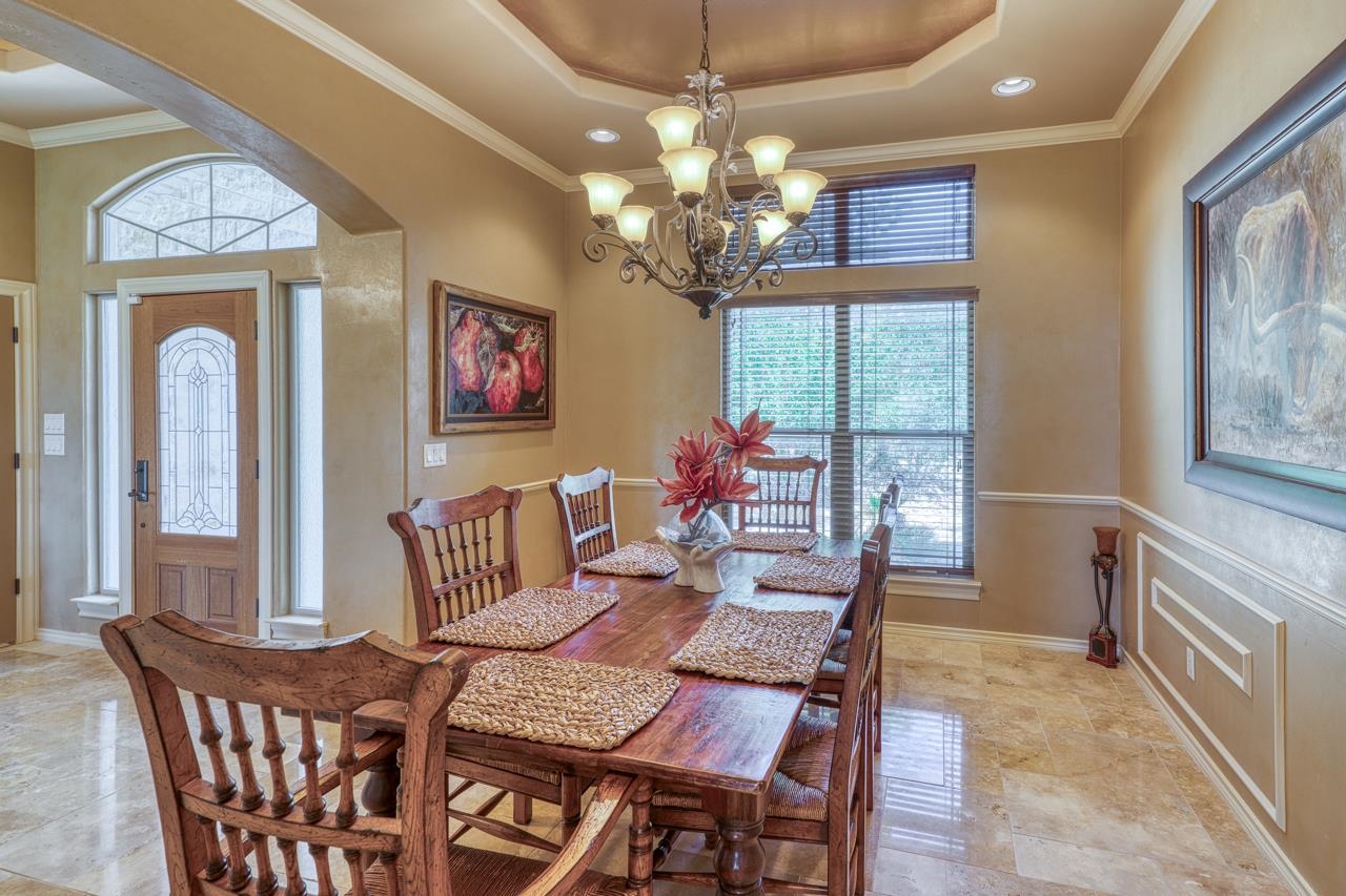 1612 Swear Injun Horseshoe Bay, TX 78657 - Photo 12 of 30 a view of a dining room with furniture a chandelier and window