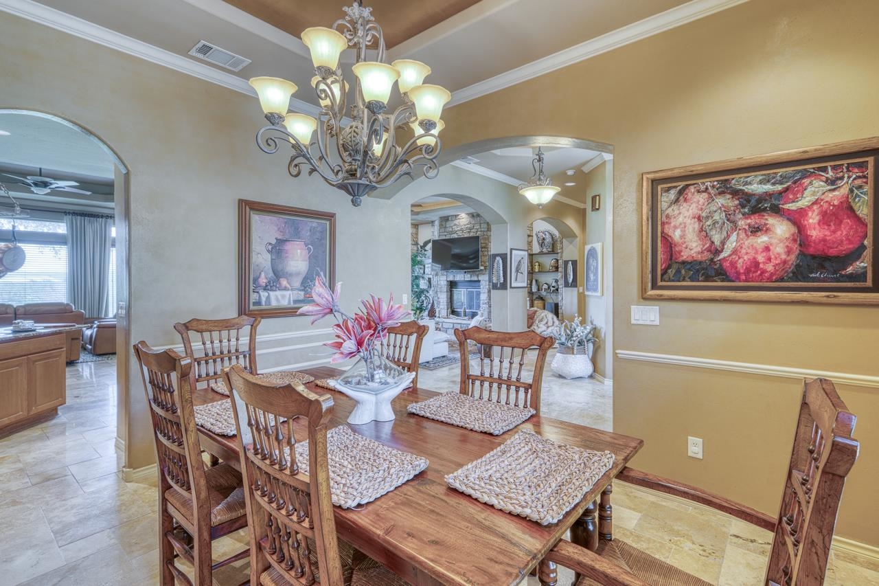 1612 Swear Injun Horseshoe Bay, TX 78657 - Photo 13 of 30 a view of a dining room with furniture and chandelier