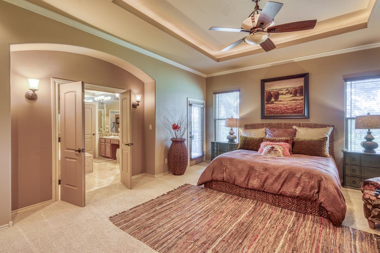 1612 Swear Injun Horseshoe Bay, TX 78657 - Photo 15 of 30 a bedroom with a bed and a chandelier