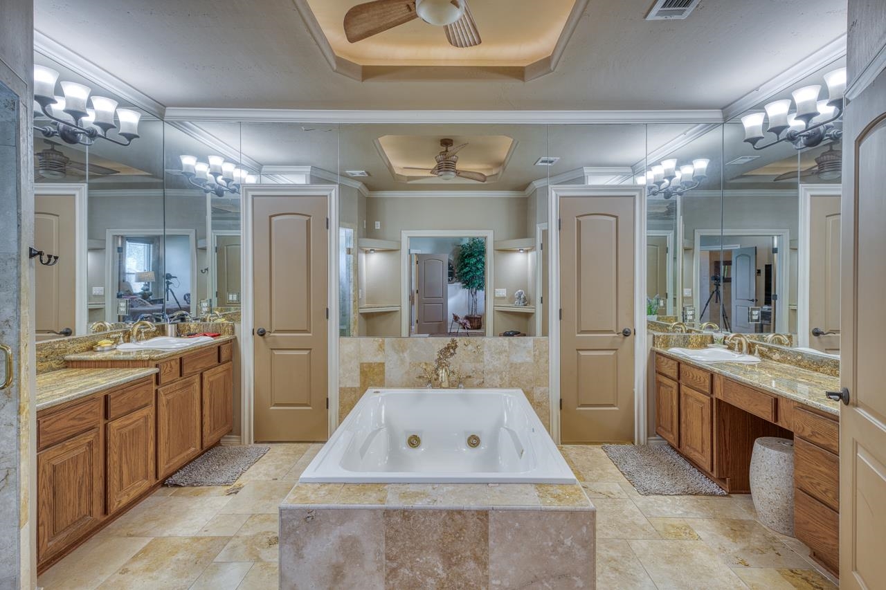 1612 Swear Injun Horseshoe Bay, TX 78657 - Photo 17 of 30 a bathroom with a tub a sink shower and a large mirror