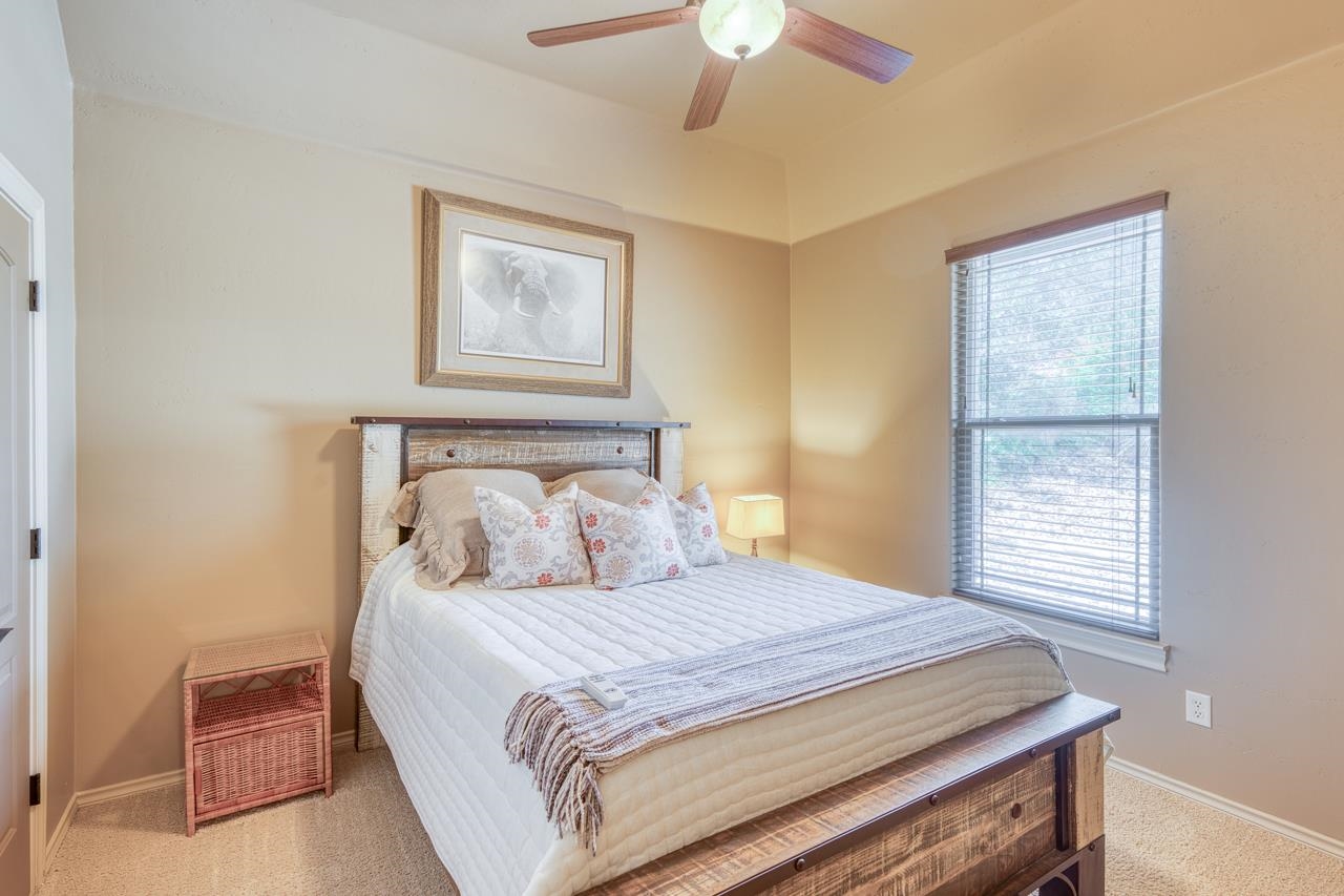 1612 Swear Injun Horseshoe Bay, TX 78657 - Photo 18 of 30 a bedroom with a bed and a window
