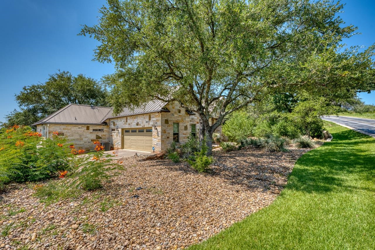 1612 Swear Injun Horseshoe Bay, TX 78657 - Photo 3 of 30 a view of a house with a tree in the yard