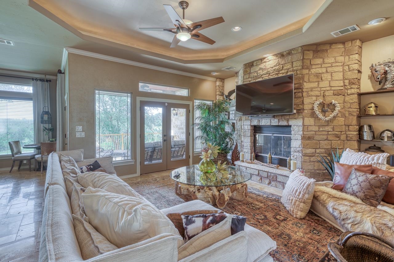 1612 Swear Injun Horseshoe Bay, TX 78657 - Photo 6 of 30 a living room with furniture a flat screen tv and a fireplace