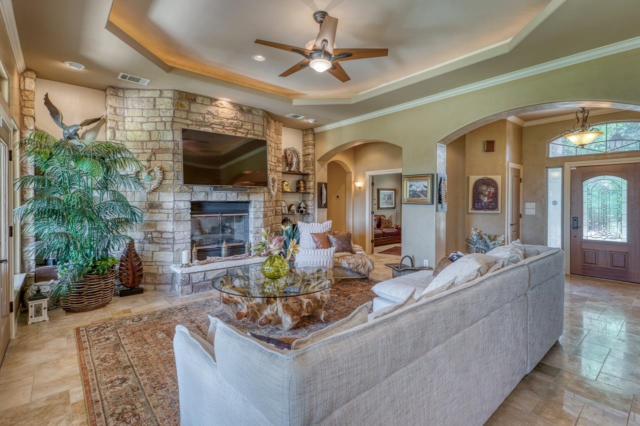 1612 Swear Injun Horseshoe Bay, TX 78657 - Photo 7 of 30 a living room with fireplace furniture and a flat screen tv