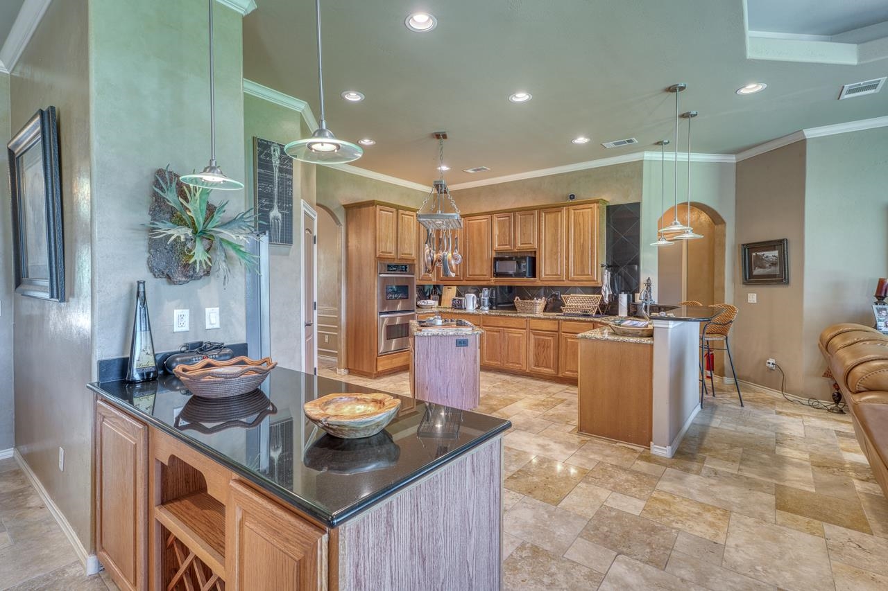 1612 Swear Injun Horseshoe Bay, TX 78657 - Photo 9 of 30 a kitchen with a refrigerator and a sink