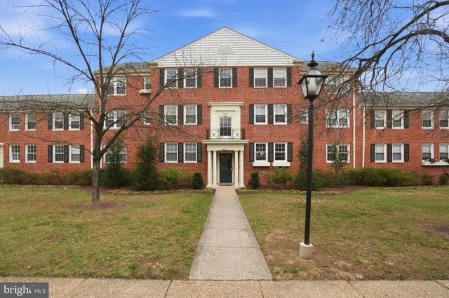 a front view of a brick house with a yard