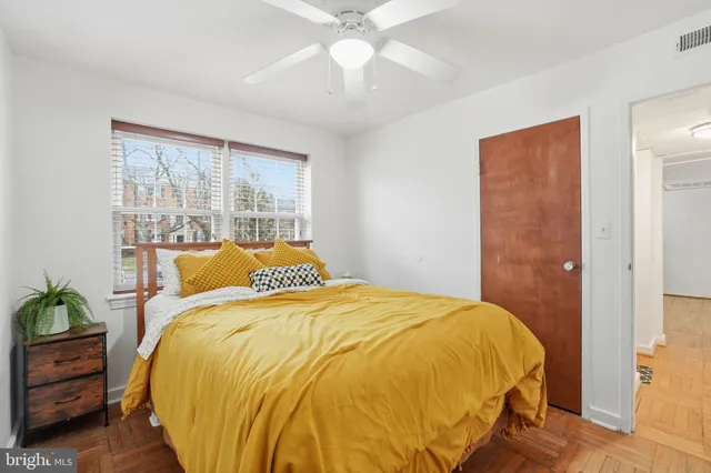 a bed sitting in a bedroom next to a window