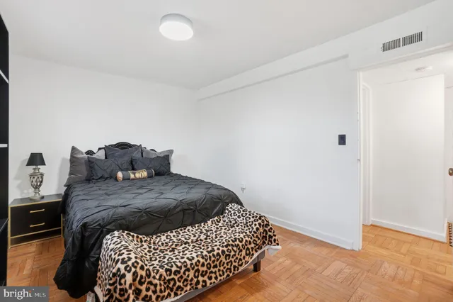 a bedroom with a bed and dresser