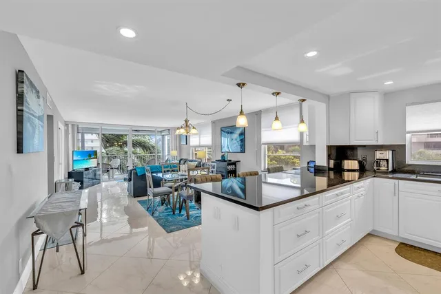 a kitchen with refrigerator a microwave a stove and cabinets