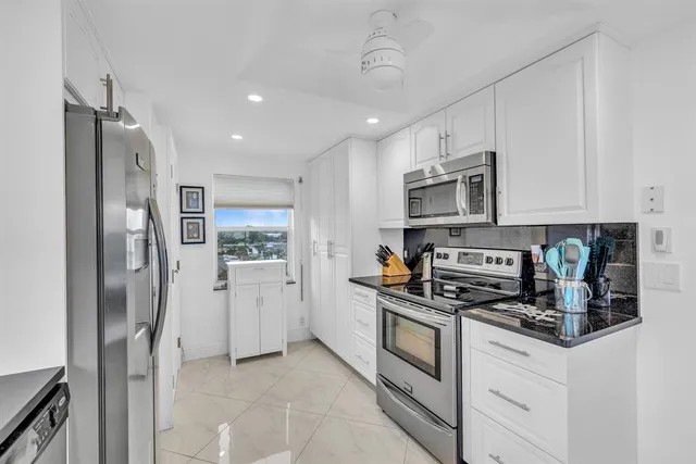a view of a dining room with furniture a rug and wooden floor