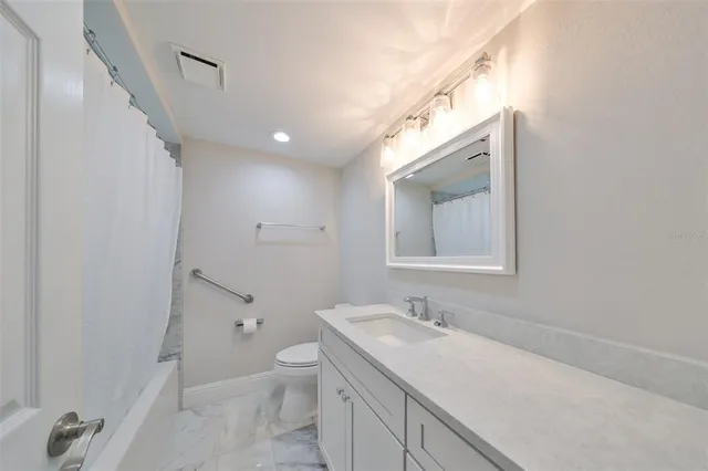 a view of bathroom with a sink mirror and toilet