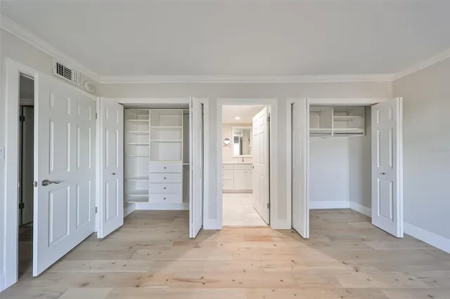 an empty room with closet and a bathroom