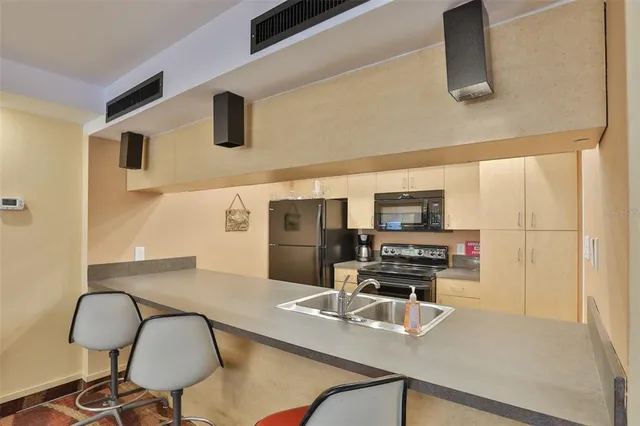 a dining room with furniture wooden floor a rug and a painting