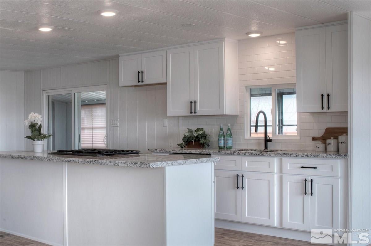 180 Chlorite Court Reno, NV 89521 - Photo 3 of 33 a kitchen with granite countertop a sink and cabinets