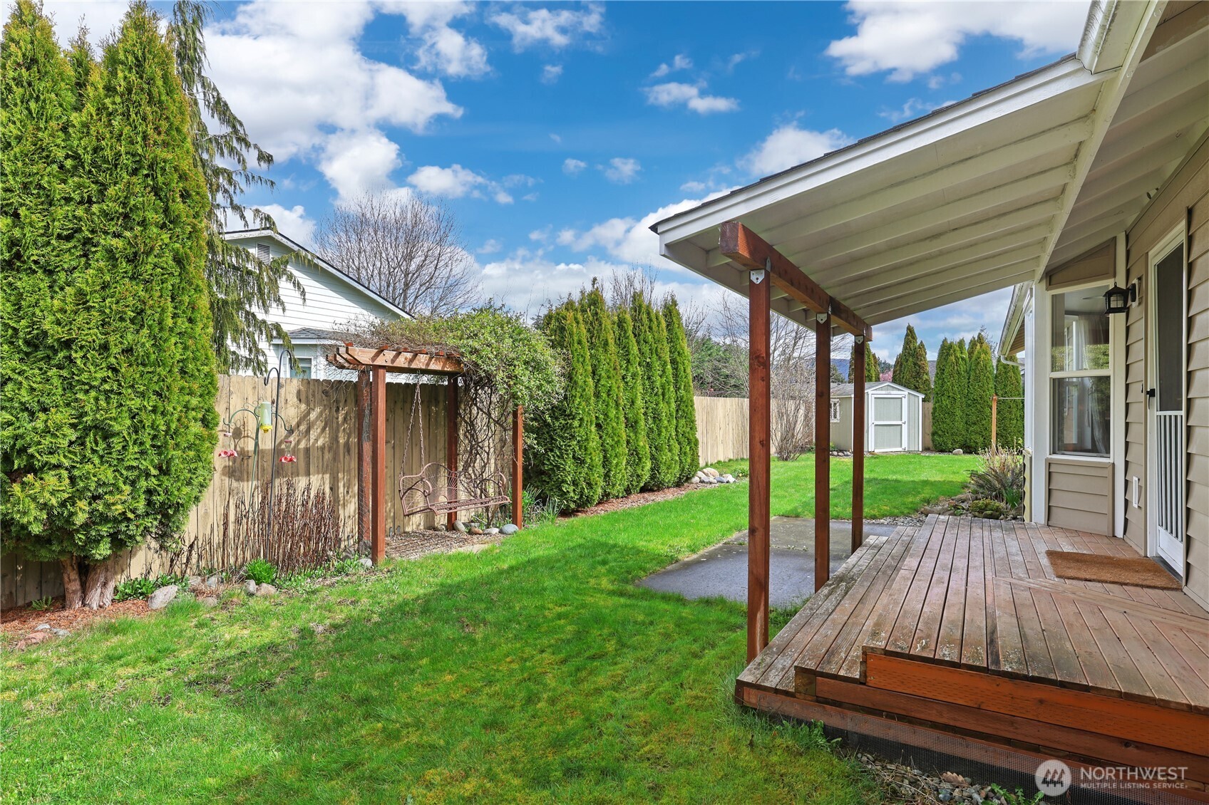 2947 Edel Avenue Enumclaw, WA 98022 - Photo 23 of 35 a view of backyard with table and chairs and wooden fence
