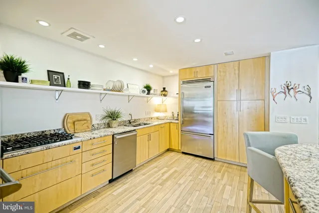 a bedroom with a bed a flat screen tv and a window