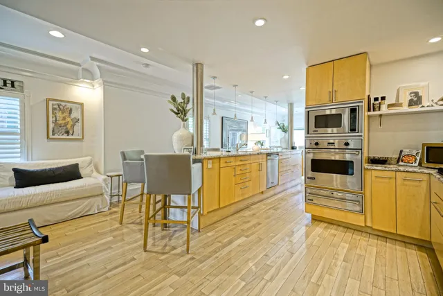 a bathroom with a granite countertop sink a toilet and a mirror