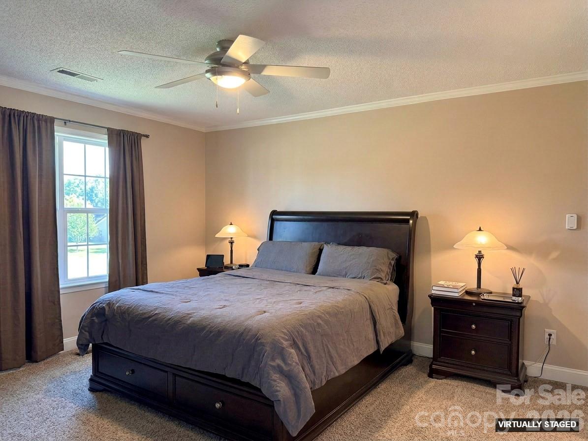 5876 St Peters Church Road Conover, NC 28613 - Photo 12 of 25 a bedroom with a bed and a chandelier