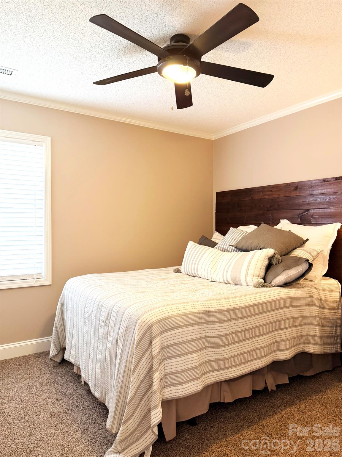 5876 St Peters Church Road Conover, NC 28613 - Photo 17 of 25 a bedroom with a bed and a ceiling fan