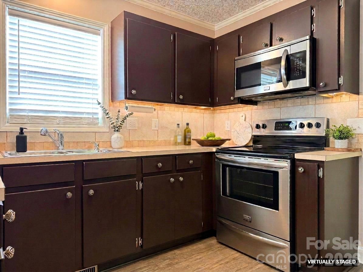 5876 St Peters Church Road Conover, NC 28613 - Photo 6 of 25 a kitchen with stainless steel appliances granite countertop a sink and a microwave