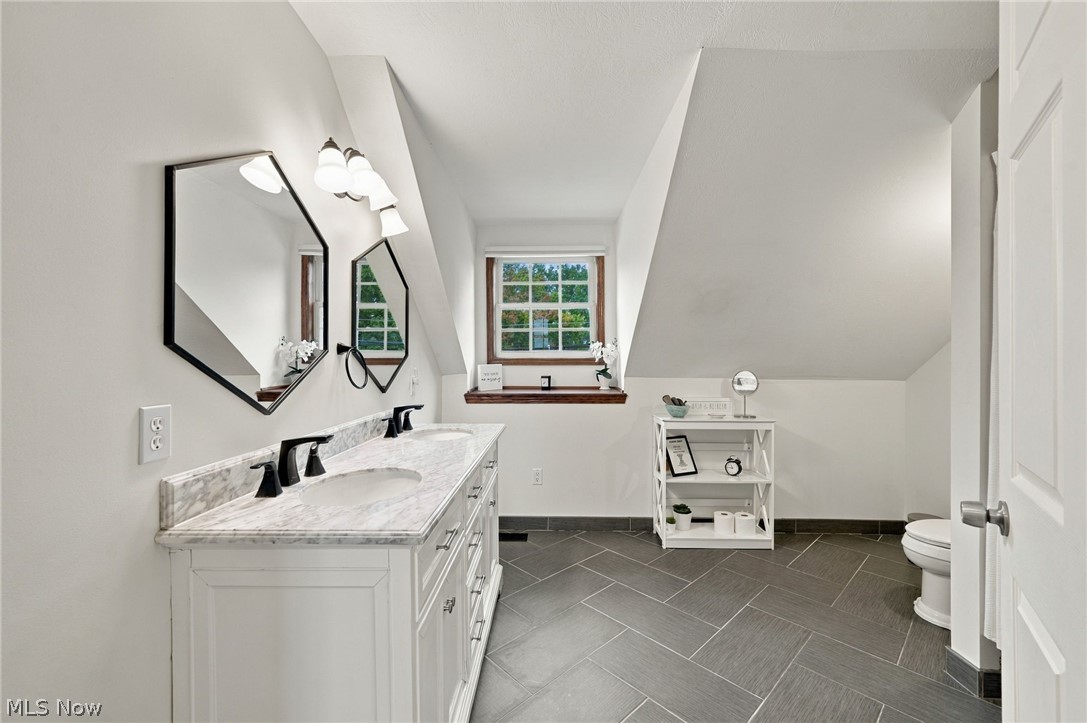 42764 Russia Road Elyria, OH 44035 - Photo 40 of 50 Dual vanity with integrated sinks, black hardware, and an expansive countertop